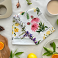 Petals of the Wild Tea Towel on the Table